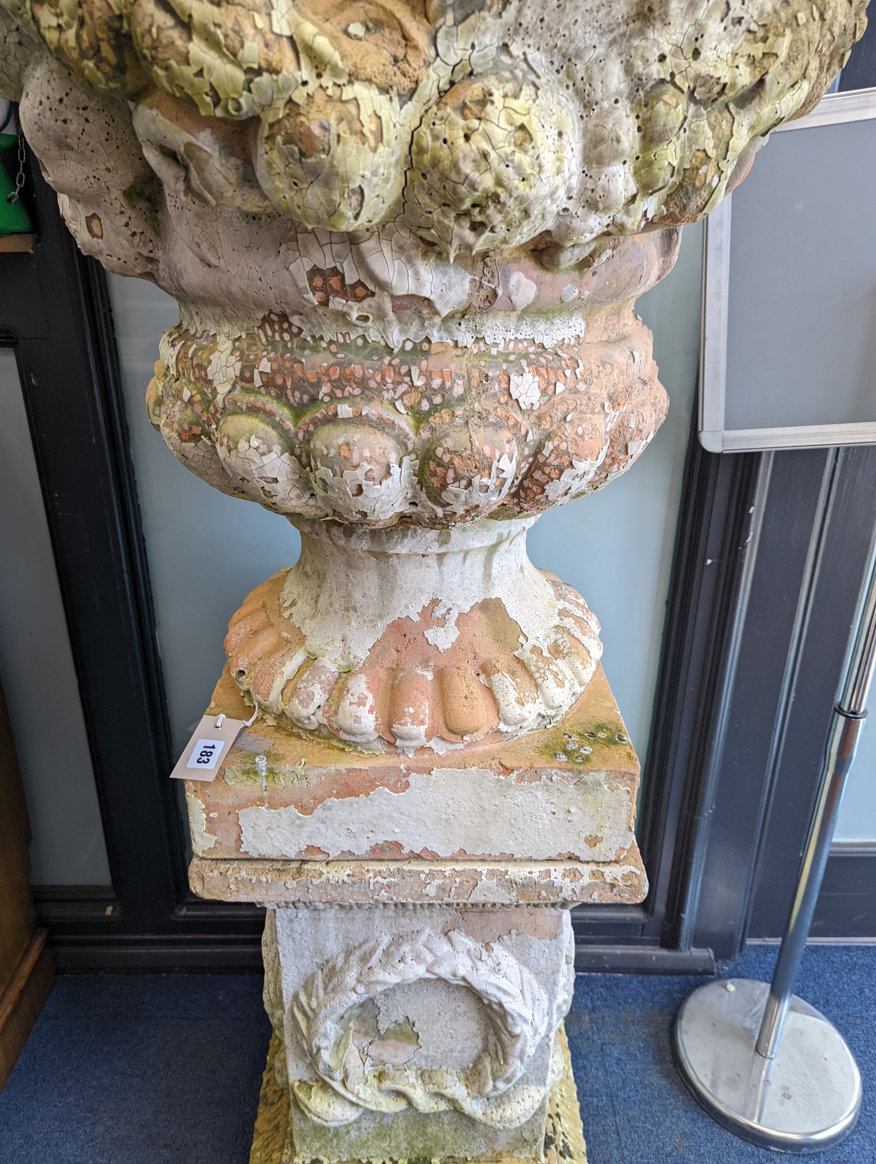 A large weathered Victorian painted terracotta lidded urn on plinth base, diameter 64cm, height 200cm